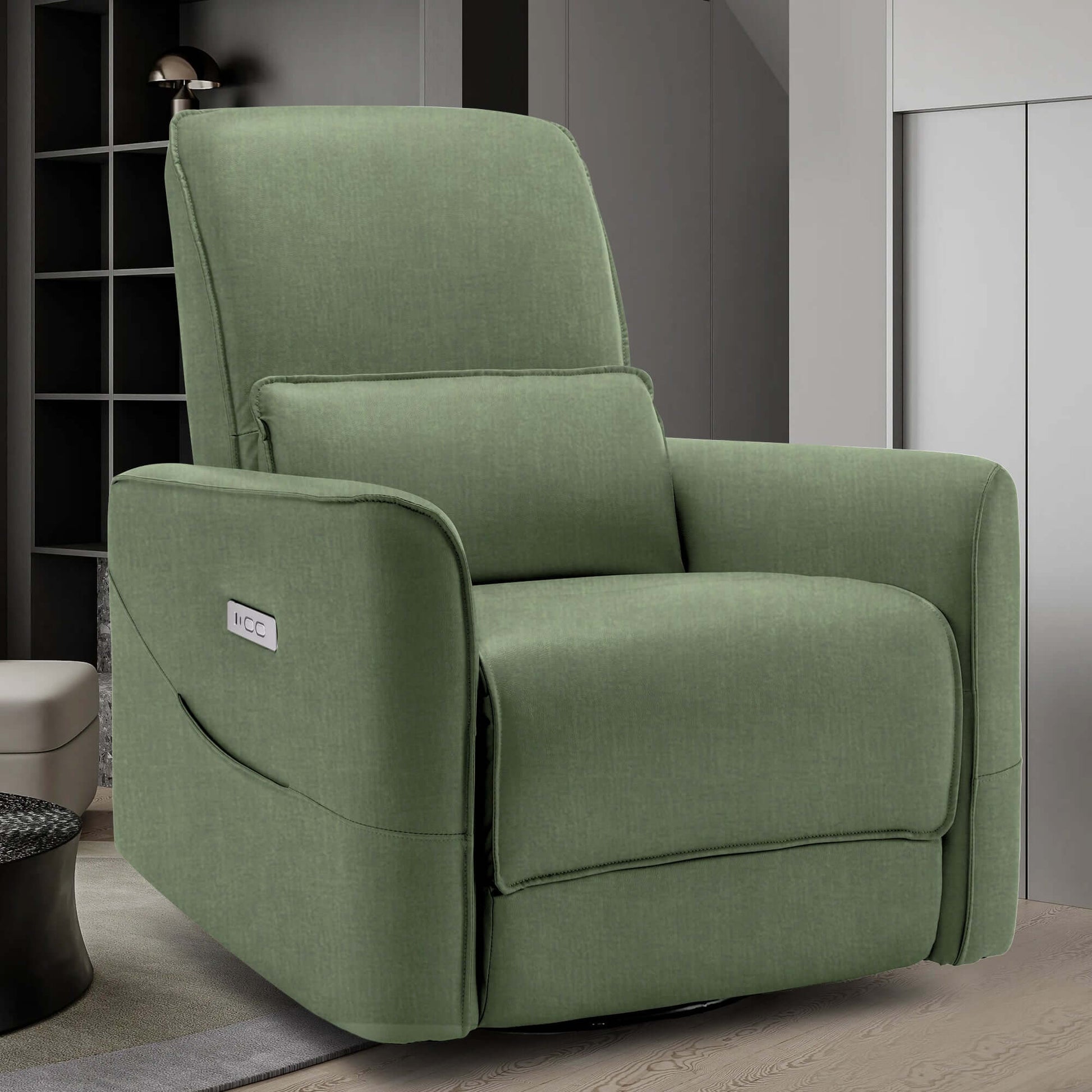 Swivel recliner chair in green upholstery, perfect for nursery, with side pockets for added convenience.
